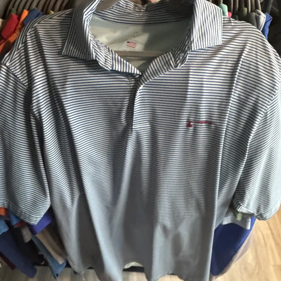 A striped golf polo with a club logo, found on a thrift store rack